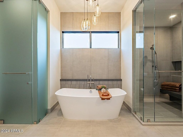 bathroom featuring tile patterned flooring and independent shower and bath