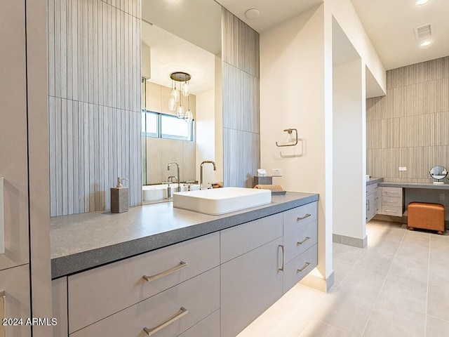 bathroom featuring tile patterned flooring, tile walls, vanity, and backsplash