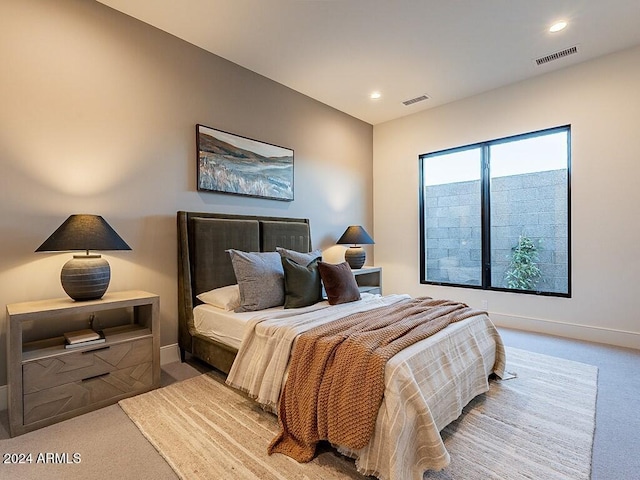 bedroom featuring light carpet