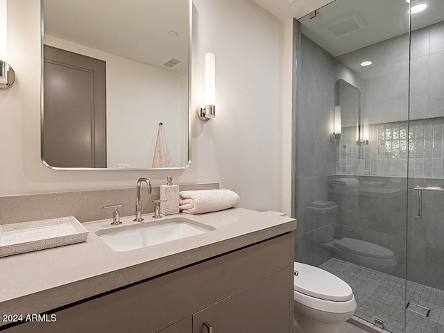 bathroom with vanity, toilet, and walk in shower