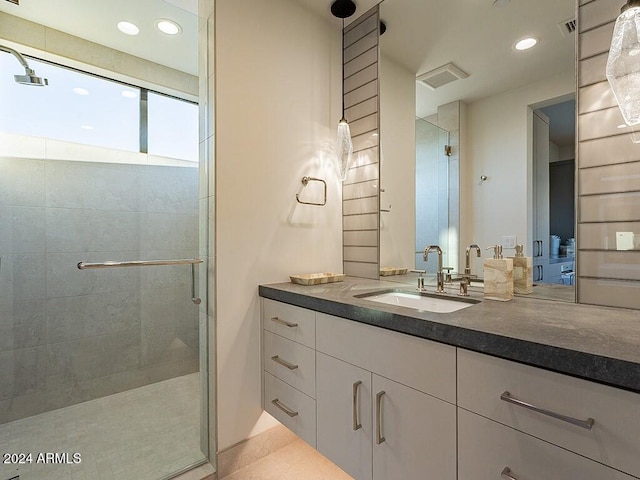 bathroom with an enclosed shower and vanity