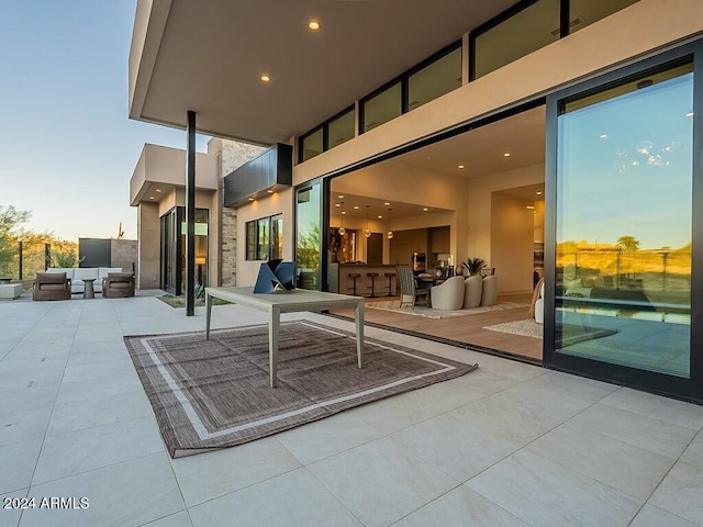 patio terrace at dusk featuring exterior bar