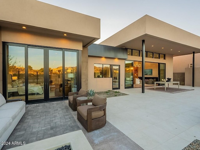 back house at dusk with a patio area