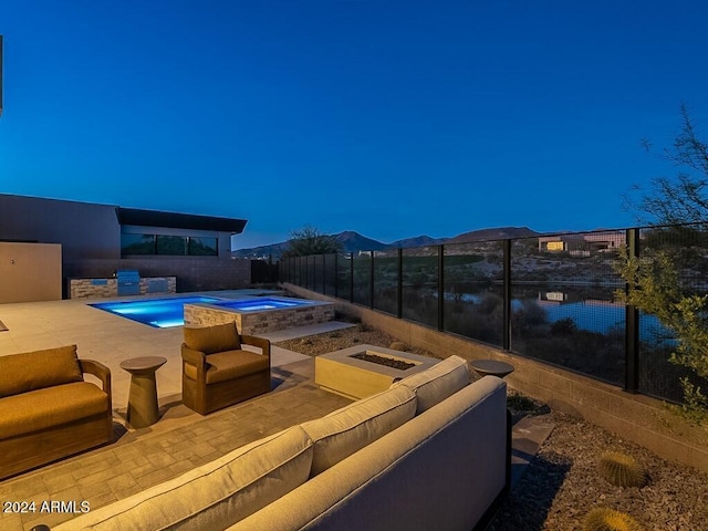 view of swimming pool featuring a patio area, an in ground hot tub, a mountain view, and an outdoor hangout area