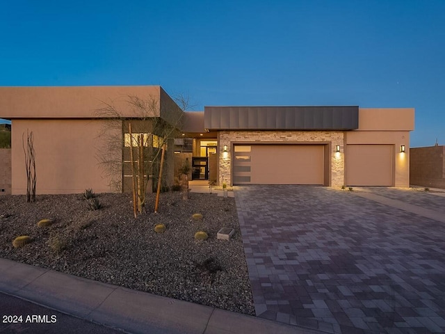 pueblo-style home featuring a garage