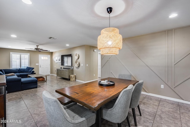 tiled dining space featuring ceiling fan