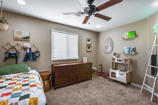 bedroom with ceiling fan and light carpet