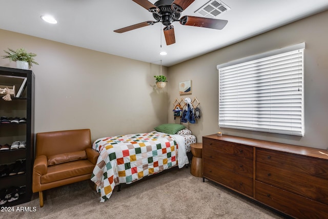 bedroom featuring ceiling fan and light carpet