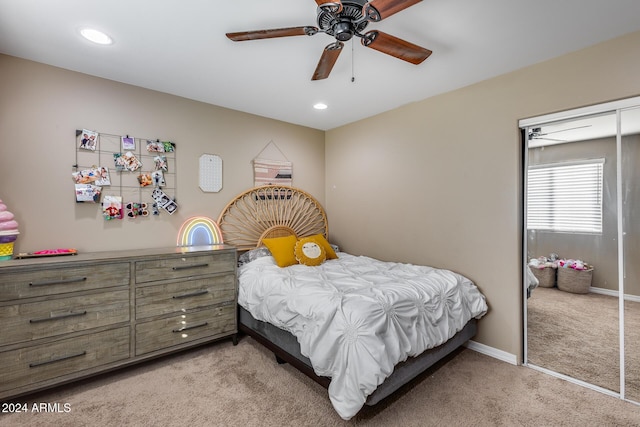 carpeted bedroom featuring a closet and ceiling fan