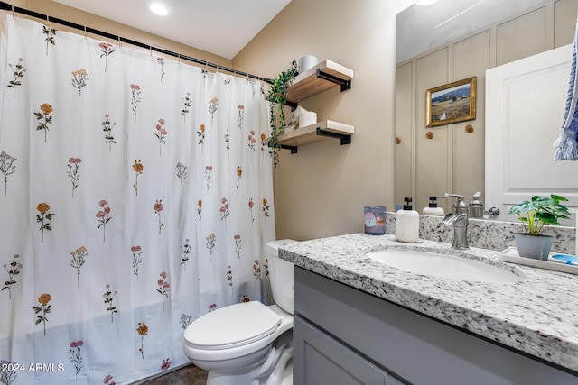 bathroom with vanity, toilet, and walk in shower