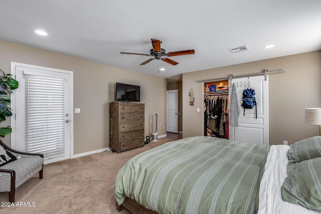 bedroom featuring ceiling fan, light colored carpet, a spacious closet, and a closet