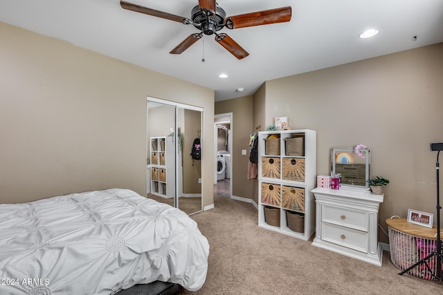 bedroom with ceiling fan, a closet, light colored carpet, and washer / dryer