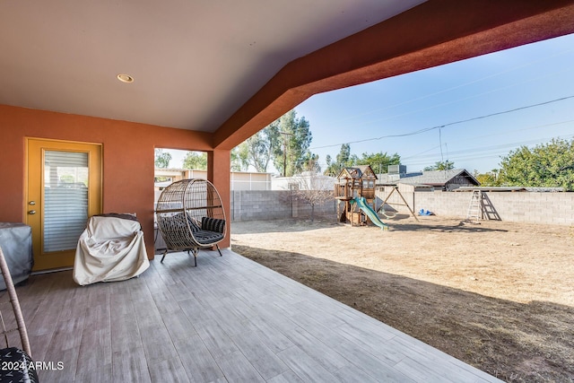 view of patio / terrace featuring a playground and a wooden deck