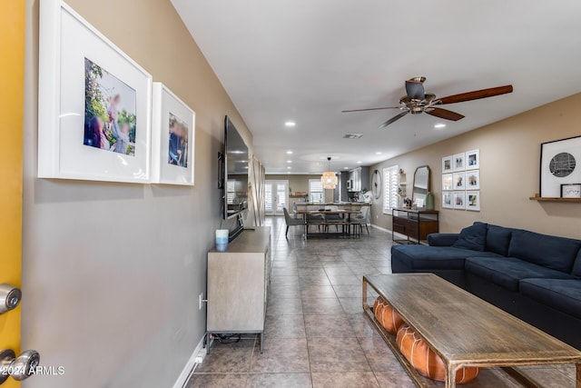 living room featuring tile patterned flooring and ceiling fan