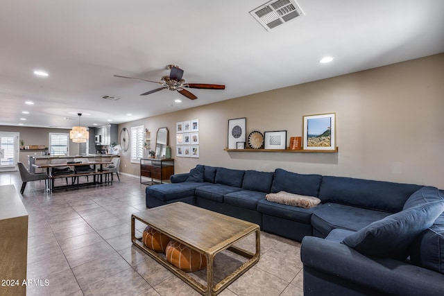 living room featuring ceiling fan and light tile patterned floors