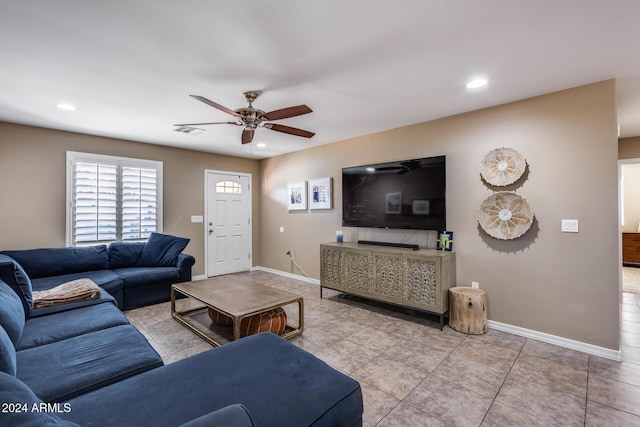 living room with ceiling fan and light tile patterned flooring