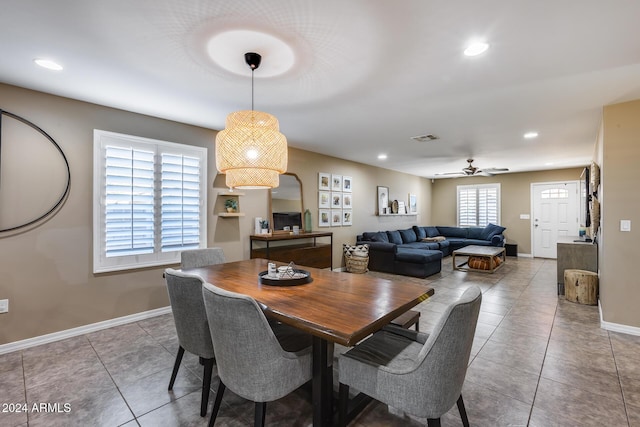 tiled dining area with ceiling fan