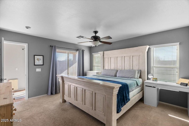 carpeted bedroom with multiple windows, a textured ceiling, and ceiling fan