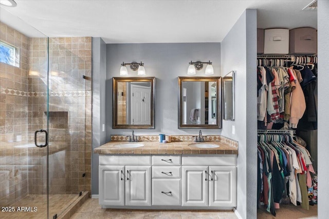 bathroom featuring vanity and an enclosed shower