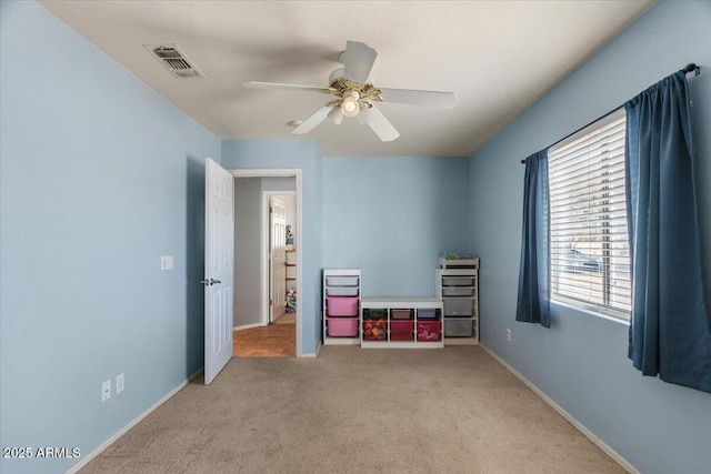 unfurnished bedroom with ceiling fan and light colored carpet