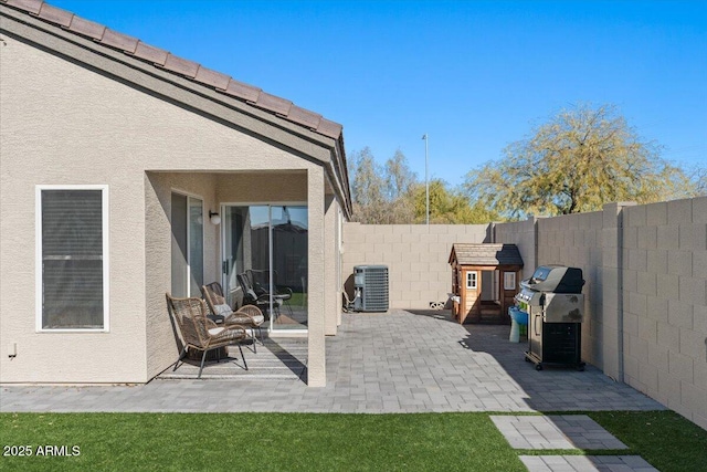 view of patio / terrace with grilling area and central air condition unit