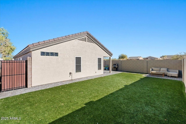 back of house with an outdoor hangout area and a lawn