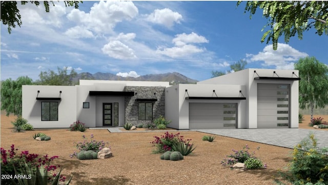 view of front of property with a garage, stone siding, a mountain view, and stucco siding