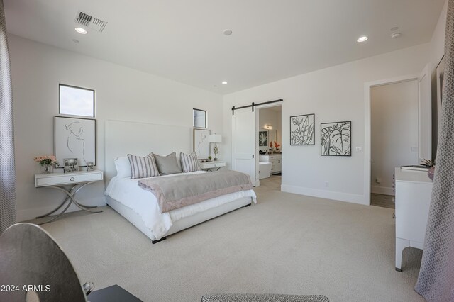 bedroom with light carpet, a barn door, visible vents, and recessed lighting