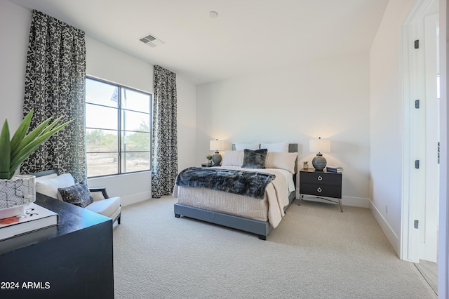 bedroom featuring baseboards, visible vents, and carpet flooring