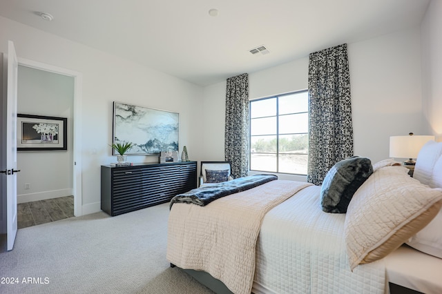 bedroom with light carpet, baseboards, and visible vents