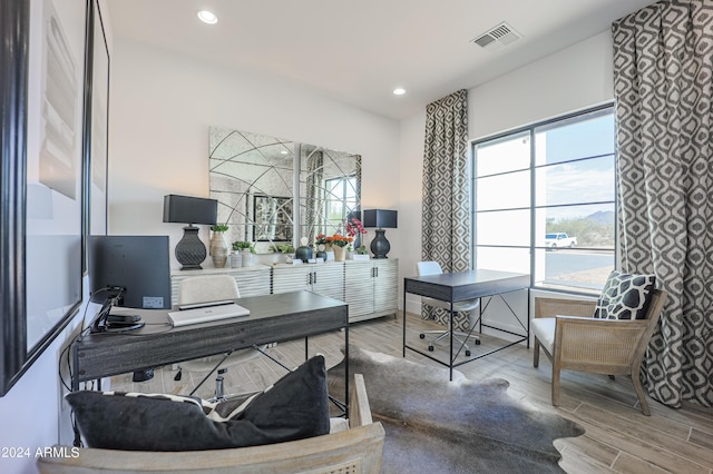 office space featuring recessed lighting, visible vents, and light wood finished floors