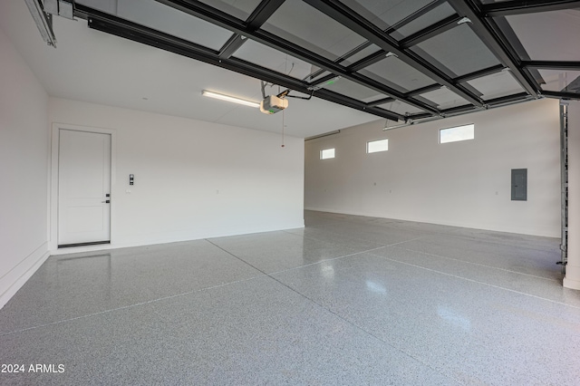 garage with electric panel and a garage door opener