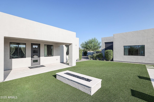 view of yard with a patio and a fire pit