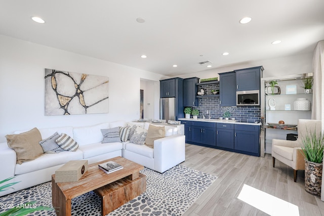 living room featuring recessed lighting and light wood finished floors