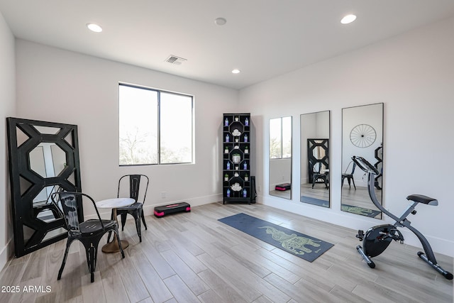 workout area featuring light wood-style flooring, visible vents, baseboards, and recessed lighting