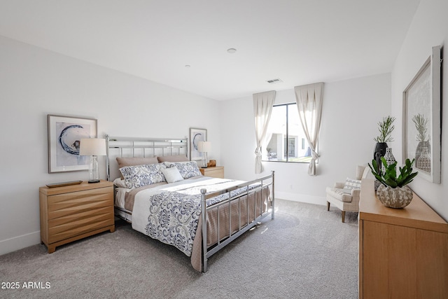 carpeted bedroom featuring visible vents and baseboards