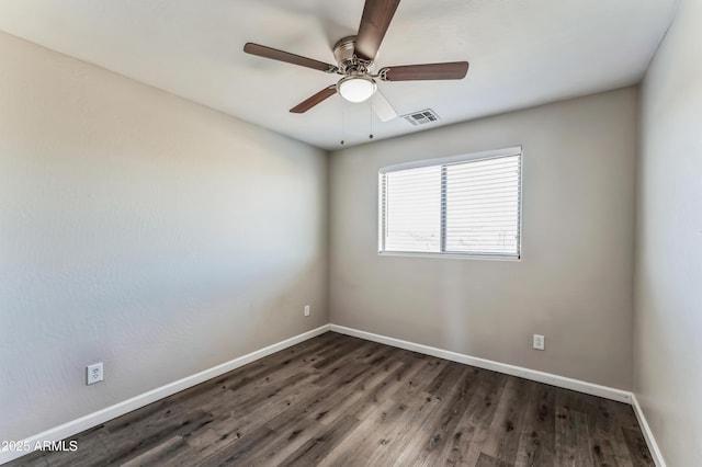 spare room with ceiling fan and dark wood-type flooring