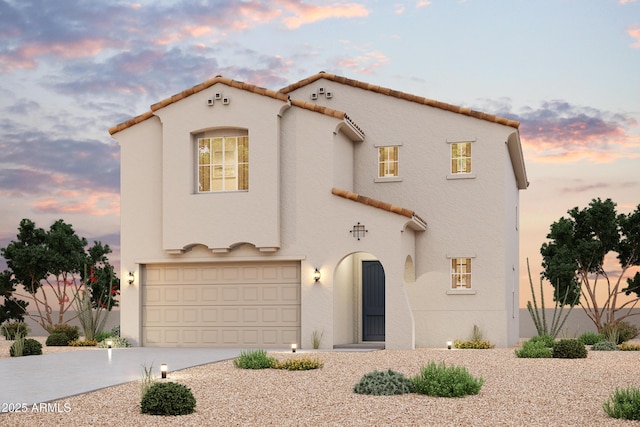 mediterranean / spanish home with a tiled roof, stucco siding, driveway, and an attached garage