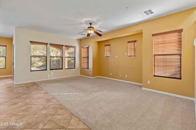 carpeted spare room with ceiling fan