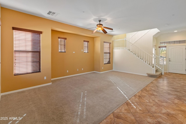 unfurnished living room with ceiling fan and light colored carpet