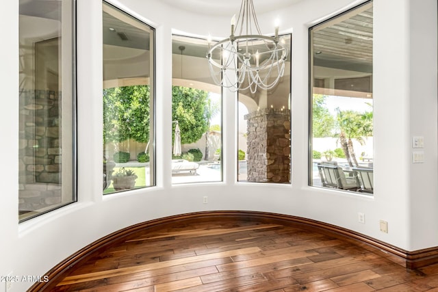 interior space with a notable chandelier and hardwood / wood-style floors