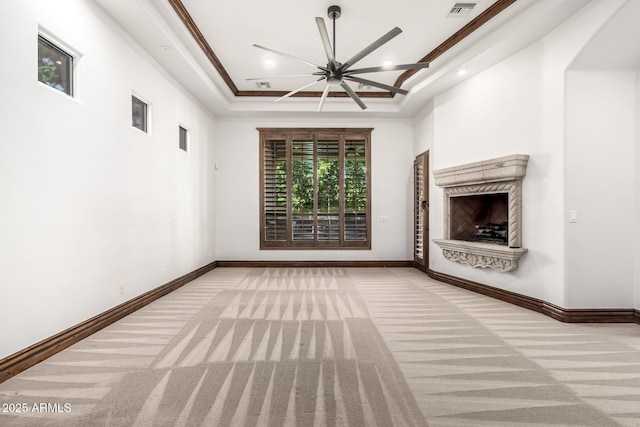 unfurnished living room featuring a high end fireplace, carpet flooring, visible vents, and recessed lighting