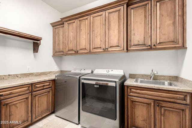 laundry area with washer and dryer, a sink, and cabinet space