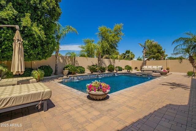 view of pool featuring outdoor lounge area, a fenced in pool, a fenced backyard, and a patio area