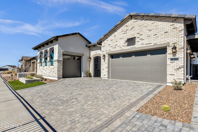 view of front of house with a garage and central AC