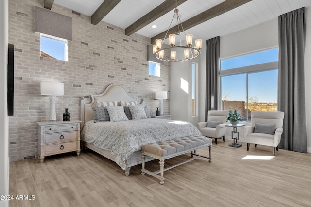 bedroom with light hardwood / wood-style flooring, brick wall, and beamed ceiling