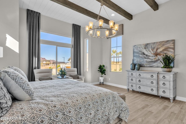 bedroom featuring light wood-type flooring, a chandelier, and beam ceiling