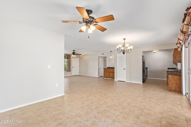 unfurnished living room with ceiling fan with notable chandelier, light tile patterned floors, visible vents, and baseboards