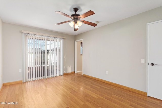 spare room with light wood-style flooring, baseboards, and ceiling fan