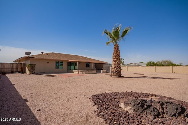 back of property featuring a fenced backyard, a patio, and stucco siding